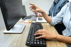 Two professional programmer cooperating and working on web site project in a software developing